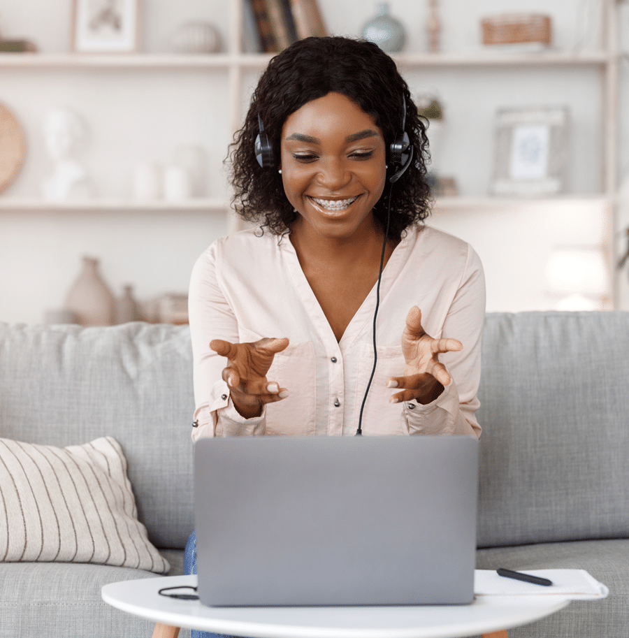 african-american-woman-smiling-with-headset-on-at-laptop