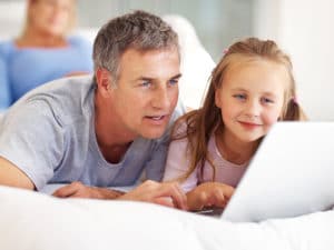 Father looking over schoolmint enrollment package with daughter